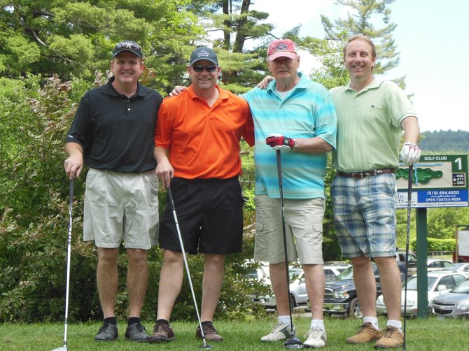 Winning first place in the Tri-Lakes Business Alliance recent benefit golf tournament was the Adrondack Moonshine team.
