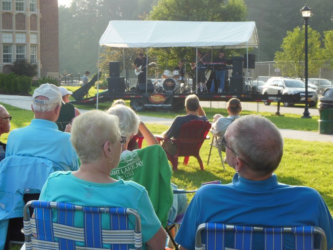 Town of Chester residents and visitors listen to the classic and contemporary rock music of the Master Cylinders band during a recent concert that featured two groups performing on the Chester Municipal Center lawn. This concert was the debut of the Music on Main Street series, jointly sponsored by the Tri-lakes Business Alliance and the town of Chester. The Alliance is launching new events and activities to revive downtown Chestertown as well as the entire northern Warren County region.