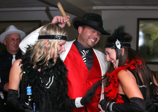Among the many partyers delving into the Roaring Twenties spirit at Speak Easy Night held last September at Panther Mountain Pub during Chestertown’s smash Rum-Runners' Weekend were (front, left to right): Janine Best, Wesley Butler Jr. and Denice Morrisseau of Brant Lake and Chester. Bob Montgomery is shown in the background. The Rum-Runners' Weekend won a Best Community Event award from the Adirondack Park Agency. Photo by Kim Ladd/Lifescapes Photography 