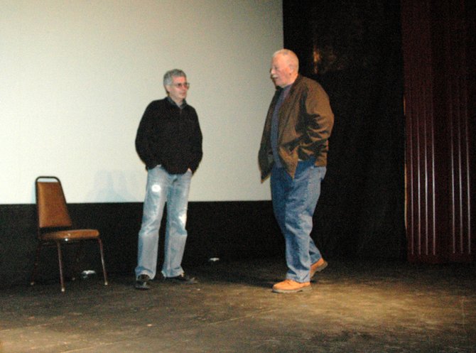 Jonathan Newell and Joe Tolomeo stand on the stage at the Carol Theatre. Tolomeo is helping to bring an arts program into the space which recently hosted the Rum Runners event.